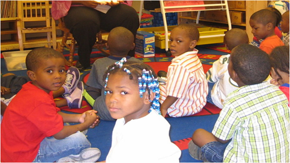 A group of children sitting on the floor.