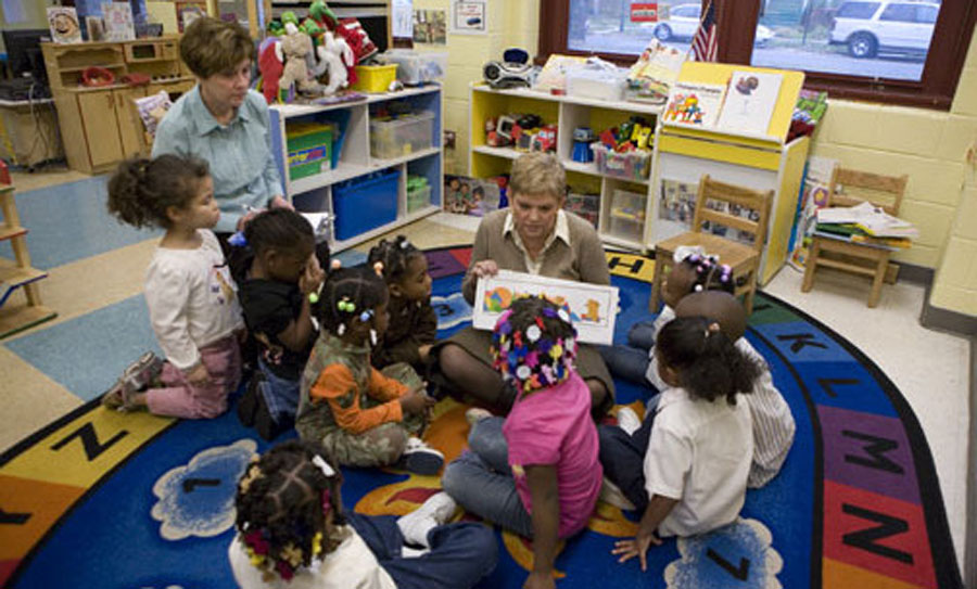 A group of children sitting around in the floor.